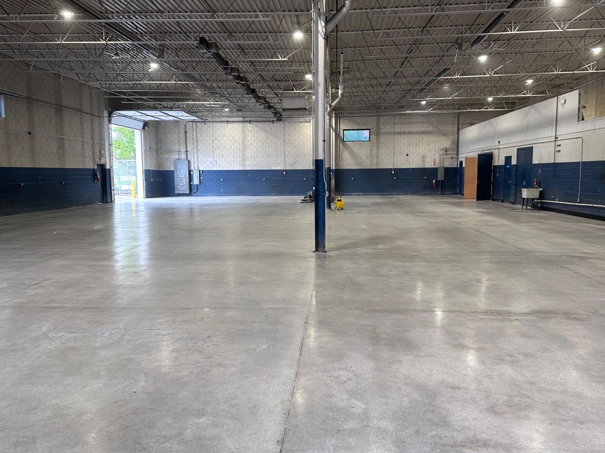 Polished concrete floor across a large industrial warehouse bay